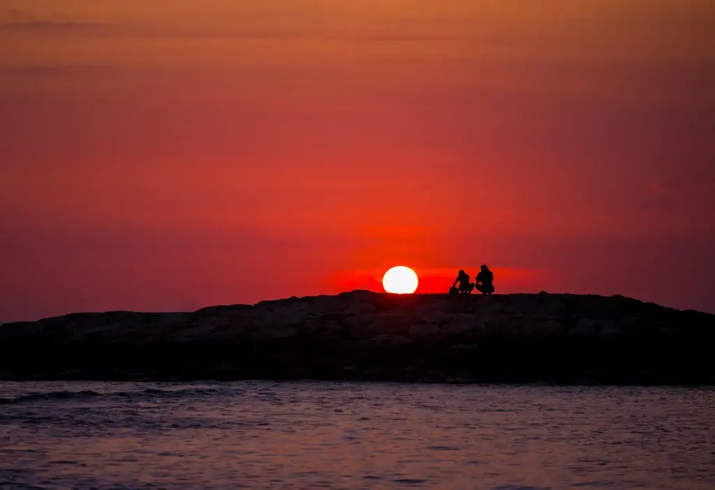 Kuta bali silhouettes of people at sunset on the beach of ku
