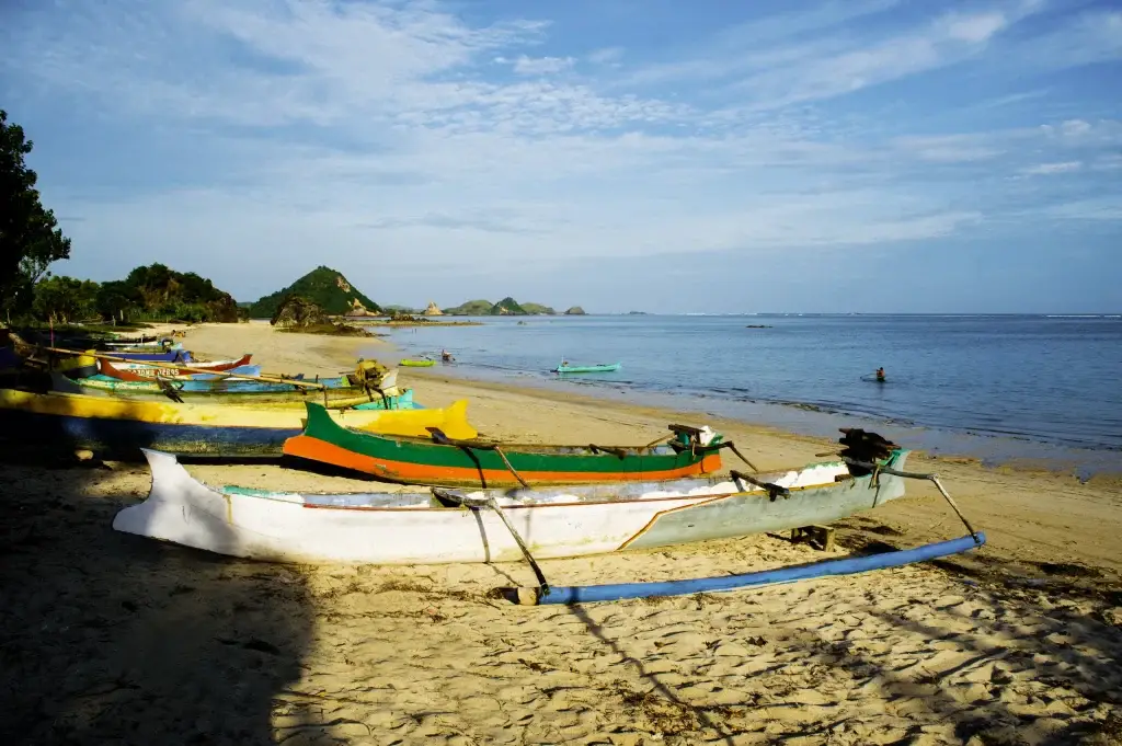 Kuta bali traditional fishing boats on kuta beach at the tra