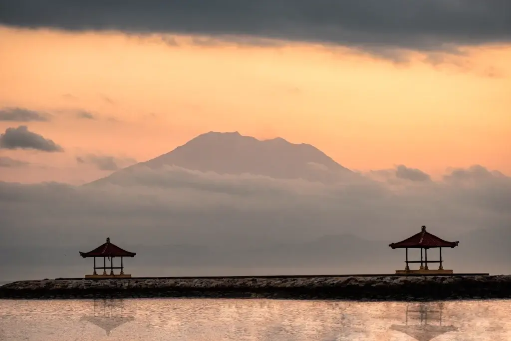 Sanur bali beach mount volcano or gunung agung with two pavilion on